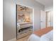 Bedroom's mirrored sliding closet doors reflect the comfy bed and ceiling fan at 4014 Trapani Pl, Las Vegas, NV 89141