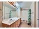 Bathroom with double sinks, large mirror, bathtub with curtain, and tile flooring at 43 E Agate Ave # 302, Las Vegas, NV 89123