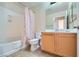Cozy bathroom featuring a shower-tub combo, wood vanity, and neutral finishes at 43 E Agate Ave # 302, Las Vegas, NV 89123