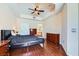 Spacious bedroom with dark furniture, tray ceilings, and hardwood flooring at 43 E Agate Ave # 302, Las Vegas, NV 89123