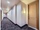 Well-lit hallway with patterned carpeting leading to apartment entrance at 43 E Agate Ave # 302, Las Vegas, NV 89123