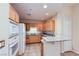 Well-equipped kitchen with light wood cabinets, granite countertops, and modern appliances at 43 E Agate Ave # 302, Las Vegas, NV 89123