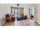 Cozy living room with tan couch, tile flooring, and a sliding door to the outside at 43 E Agate Ave # 302, Las Vegas, NV 89123