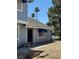 Charming home exterior with blue awnings, landscaping, and a welcoming front entrance at 5420 Centurion Ct # 104, Las Vegas, NV 89122