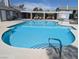 Beautiful community pool with a pergola, lounge chairs and shallow end at 5420 Centurion Ct # 104, Las Vegas, NV 89122