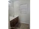 Bathroom vanity with dark cabinets and tile floor at 5651 Bettors Luck Ct, Las Vegas, NV 89122