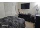 Cozy bedroom featuring ample closet space and a mounted television at 5651 Bettors Luck Ct, Las Vegas, NV 89122