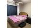 Bedroom with a ceiling fan, and a bed with a pink patterned comforter at 5651 Bettors Luck Ct, Las Vegas, NV 89122