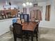 Dining room with a chandelier, a large, wooden dining table and six upholstered chairs at 5651 Bettors Luck Ct, Las Vegas, NV 89122