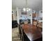 This is the dining room with an ornate table, chandelier, and view to the kitchen at 5651 Bettors Luck Ct, Las Vegas, NV 89122
