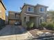 Two-story home with a two-car garage, balcony, and a well-kept lawn with mature landscaping at 5651 Bettors Luck Ct, Las Vegas, NV 89122