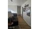 Second floor hallway featuring wood floors, a comfortable sofa and multiple framed pictures at 5651 Bettors Luck Ct, Las Vegas, NV 89122