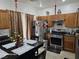 Kitchen featuring stainless steel appliances, wood cabinets, granite counters, and an island at 5651 Bettors Luck Ct, Las Vegas, NV 89122
