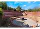 Backyard with a terraced retaining wall and patio with a built-in fire pit, perfect for entertaining at 5735 Oak Bend Dr, Las Vegas, NV 89135