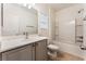Well-lit bathroom with single sink vanity, framed mirror, and shower-tub combination at 5735 Oak Bend Dr, Las Vegas, NV 89135