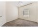 Clean bedroom featuring neutral carpet, a window for natural light, and a ceiling fan at 5735 Oak Bend Dr, Las Vegas, NV 89135