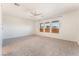 Expansive bedroom with neutral carpet, ceiling fan, and large windows providing lots of natural light at 5735 Oak Bend Dr, Las Vegas, NV 89135