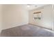 Neutral bedroom featuring carpeted floors, ceiling fan, and window with woven shade at 5735 Oak Bend Dr, Las Vegas, NV 89135