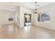 Bright dining area featuring tile floors, modern lighting fixture, and large windows with views to backyard at 5735 Oak Bend Dr, Las Vegas, NV 89135