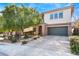 Charming two-story home featuring desert landscaping, stone accents, a brick driveway, and an attached two-car garage at 5735 Oak Bend Dr, Las Vegas, NV 89135
