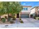 Charming two-story home featuring desert landscaping, stone accents, a brick driveway, and an attached two-car garage at 5735 Oak Bend Dr, Las Vegas, NV 89135