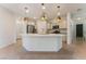 Bright, open kitchen with a large island, stainless steel appliances, and elegant pendant lighting at 5735 Oak Bend Dr, Las Vegas, NV 89135