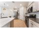 Spacious kitchen featuring stainless steel appliances, gray subway tile backsplash, and a large island at 5735 Oak Bend Dr, Las Vegas, NV 89135