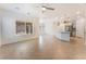 Open-concept living room with tile floors and plenty of natural light, adjacent to the kitchen at 5735 Oak Bend Dr, Las Vegas, NV 89135