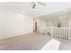 Upstairs loft area featuring neutral carpet, a ceiling fan, and views of the staircase below at 5735 Oak Bend Dr, Las Vegas, NV 89135