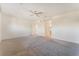 Large carpeted bedroom featuring a ceiling fan, a barn door closet, and access to an ensuite bathroom at 5735 Oak Bend Dr, Las Vegas, NV 89135