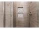 Tiled shower stall with built-in shower caddy and glass surround at 5735 Oak Bend Dr, Las Vegas, NV 89135