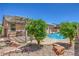 Landscaped backyard with a swimming pool and an outdoor kitchen area at 5889 Wildhorse Ledge Ave, Las Vegas, NV 89131