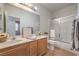 Bright bathroom with a double sink vanity, framed mirror and shower and tub combo at 5889 Wildhorse Ledge Ave, Las Vegas, NV 89131