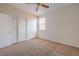 Bedroom with neutral carpet, three closets, and ceiling fan at 5889 Wildhorse Ledge Ave, Las Vegas, NV 89131