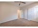Bedroom featuring neutral carpet, multiple closets and ceiling fan at 5889 Wildhorse Ledge Ave, Las Vegas, NV 89131
