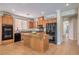 Modern kitchen features wood cabinetry, an island with granite countertops, and high-end appliances at 5889 Wildhorse Ledge Ave, Las Vegas, NV 89131