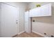 Functional laundry room with built-in cabinets for easy storage and organization at 5889 Wildhorse Ledge Ave, Las Vegas, NV 89131