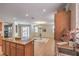 Open layout showcases the kitchen island flowing into the living area with a chandelier at 5889 Wildhorse Ledge Ave, Las Vegas, NV 89131