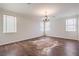 Inviting living room with hardwood floors, a chandelier, and natural light from the windows at 5889 Wildhorse Ledge Ave, Las Vegas, NV 89131