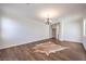 Well-lit living room with hardwood floors, a chandelier, and a view of the hallway at 5889 Wildhorse Ledge Ave, Las Vegas, NV 89131