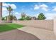 A serene backyard features a small patch of artificial grass and privacy wall at 632 Hitchen Post Dr, Henderson, NV 89011