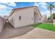 Home's backyard has an artificial lawn, gravel yard, and a block wall at 632 Hitchen Post Dr, Henderson, NV 89011