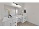 Bathroom featuring double sinks, modern fixtures, and ample counter space at 632 Hitchen Post Dr, Henderson, NV 89011