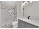 Modern bathroom features a glass-enclosed shower with marble tile and sleek gray vanity at 632 Hitchen Post Dr, Henderson, NV 89011