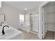 Bright bathroom showcasing double sinks, a tub, shower, and a walk-in closet at 632 Hitchen Post Dr, Henderson, NV 89011