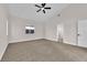 Bedroom with neutral carpet, ceiling fan, and ample natural light at 632 Hitchen Post Dr, Henderson, NV 89011