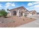 Landscaped single-story home featuring desert landscaping, tile roof, and two-car garage at 632 Hitchen Post Dr, Henderson, NV 89011