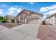 Inviting single-story home with a tile roof, two-car garage, and desert landscaping at 632 Hitchen Post Dr, Henderson, NV 89011