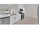 Stylish kitchen featuring white cabinets, stainless steel appliances, and a spacious island at 632 Hitchen Post Dr, Henderson, NV 89011