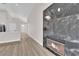 Open living area with a stone fireplace, high ceilings, and light wood flooring at 632 Hitchen Post Dr, Henderson, NV 89011